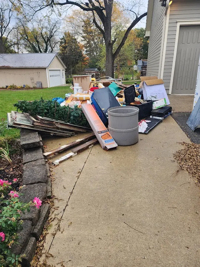 Dumpster being loaded with debris for Estate Cleanout Dumpster Rental in Wilton Manors